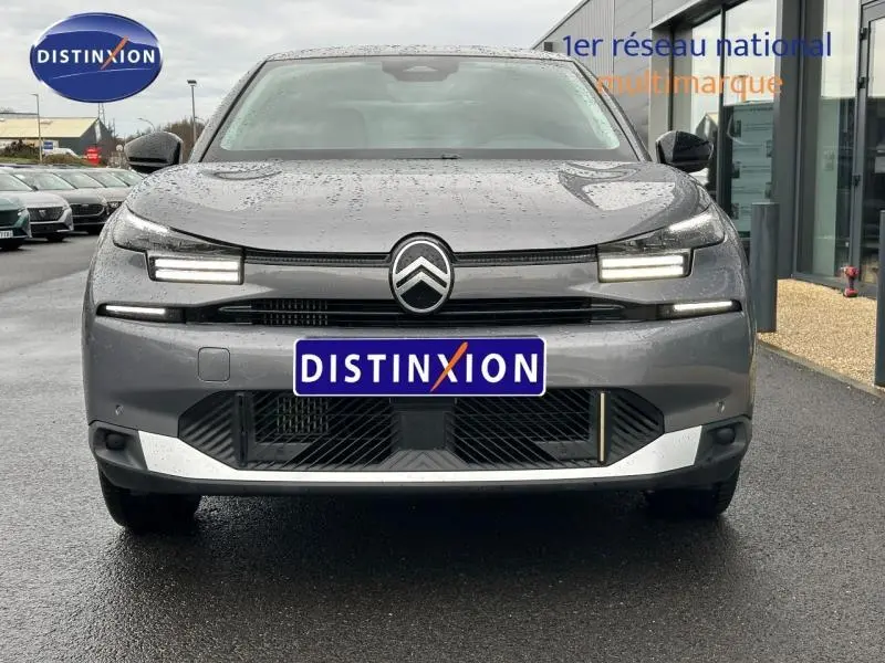 Vue frontale d'une Citroën C4 X 1.2 Hybride gris Mercury 2025 avec phares LED distinctifs et calandre moderne.