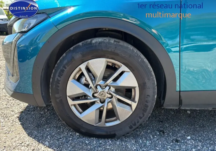 Gros plan sur la roue avant gauche et la jante alu d’un Peugeot 408 Hybrid 145 allure bleu 2025.