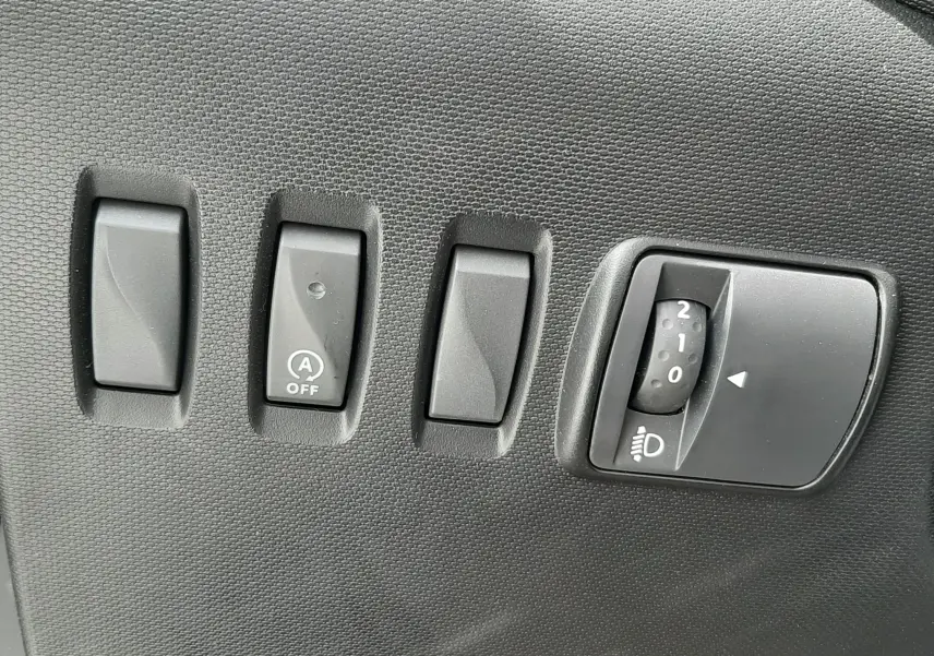 Vue plongeante sur la console centrale de la Renault Twingo III Life 2021, montrant frein à main et sièges tissu gris à motifs.