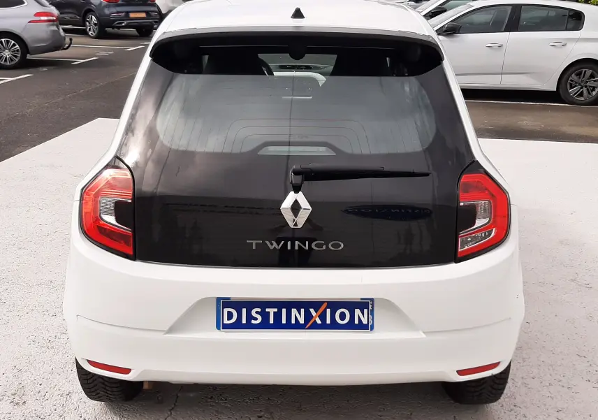 Vue 3/4 arrière droite d'une Renault Twingo III blanche cristal, avec vitres teintées et jantes alliage.