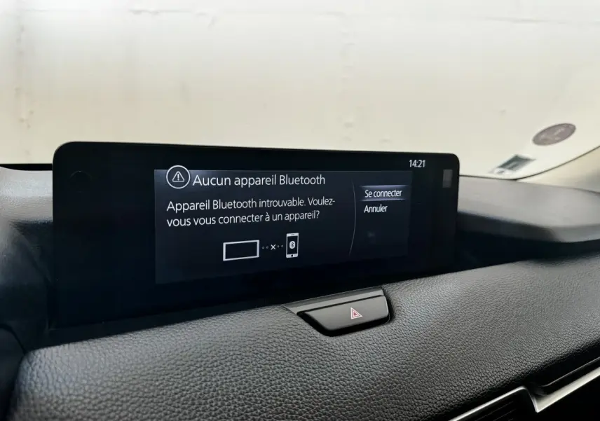Écran tactile central affichant un message Bluetooth dans l’habitacle du Mazda CX-60 noir, vue intérieure rapprochée.