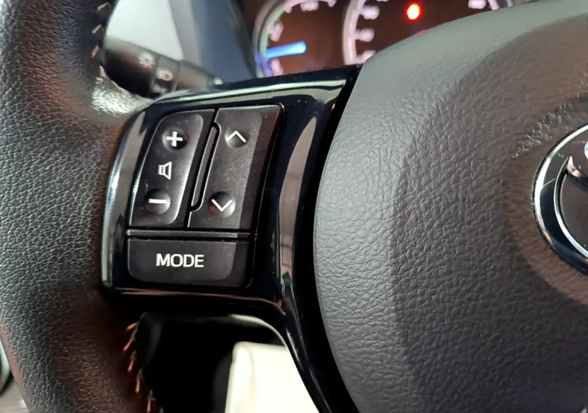 Gros plan sur le volant cuir et alu de la Toyota Yaris 1.5 Hybride 2020 avec commandes multifonctions visibles.