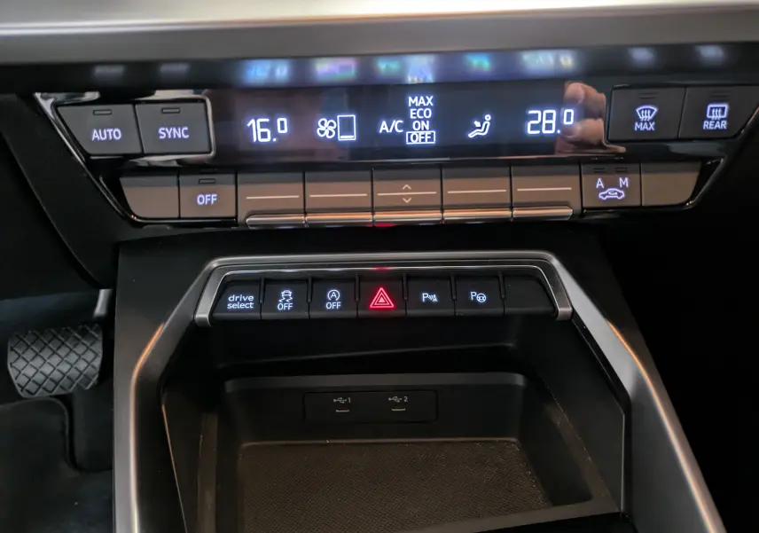 Détail du tableau de bord de l'Audi A3 Sportback 35 TDI 2021 montrant les commandes climatisation et aides à la conduite.