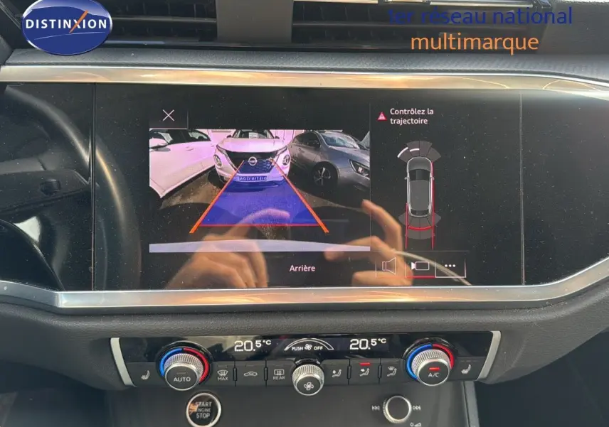 Écran central affichant la caméra de recul avec alertes, dans l'habitacle d'un Audi Q3 Sportback blanc 2021.