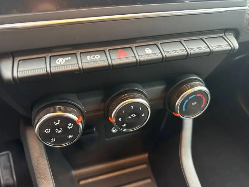Gros plan sur les commandes de climatisation et boutons de fonction noirs du tableau de bord de la Renault Clio 1.0 TCe 90ch Evolution 2025.