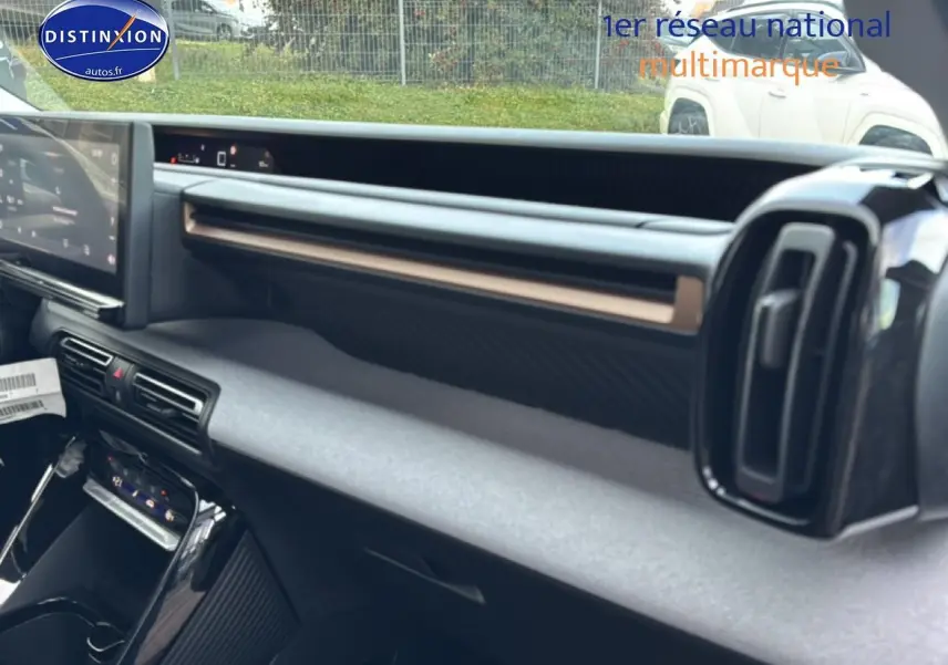 Vue intérieure côté passager du tableau de bord noir du Citroën C3 Aircross 2025 avec écran tactile et aérateurs verticaux.