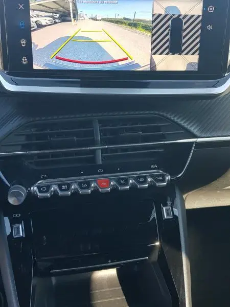 Vue intérieure du tableau de bord du Peugeot 2008 Hybrid 145 Allure 2025, écran tactile affichant la caméra de recul.