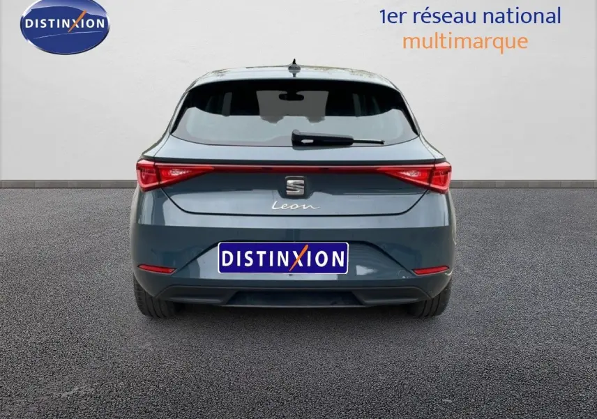 Vue arrière d'une SEAT Leon gris magnétique métal 2025 avec feux LED et logo distinctif sur fond neutre.