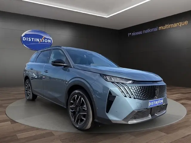 Peugeot 5008 hybride bleu en 3/4 avant droit, avec calandre distinctive et jantes noires brillantes.