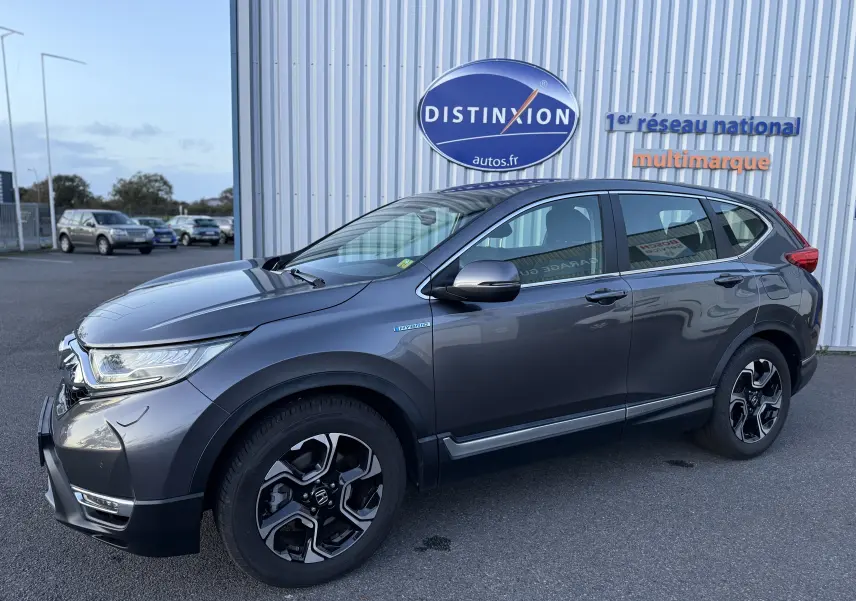 Honda CR-V Hybrid 184 Elegance gris vu de profil côté gauche, avec jantes noires et détails hybrides visibles.