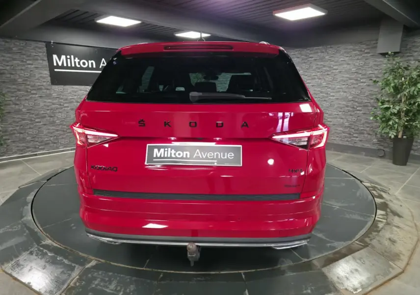 Vue arrière d'un Skoda Kodiaq rouge 2021 avec hayon électrique et crochet d'attelage escamotable visible.
