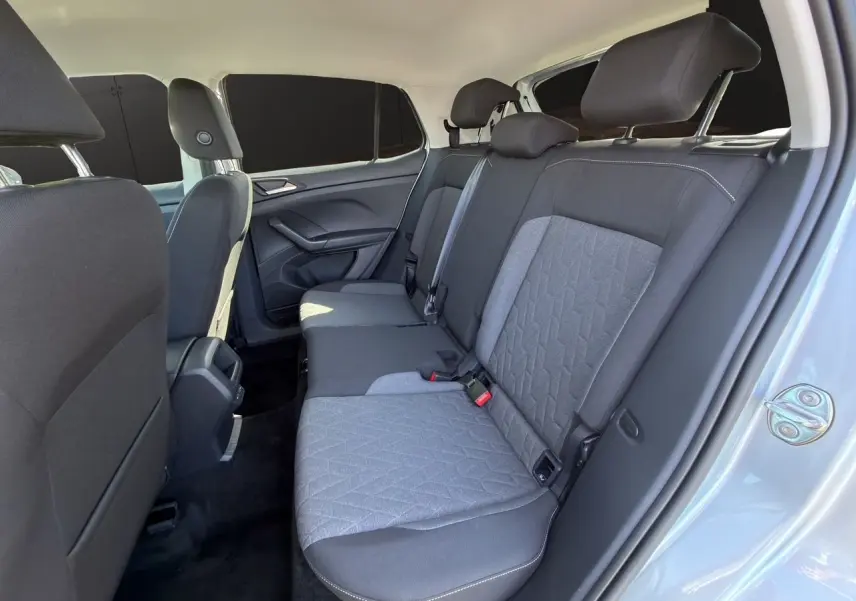 Vue intérieure côté droit sur la banquette arrière tissu gris et noir du Volkswagen T-Cross reflet d'argent 2025.