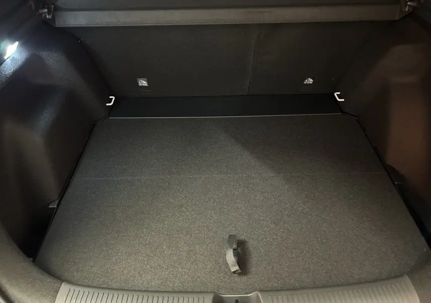 Vue intérieure du coffre spacieux et propre du MG ZS 1.5 Hybrid+ 197 Luxury en Dover White, avec éclairage latéral.