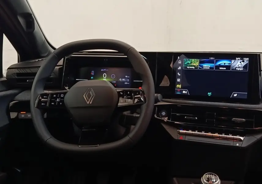 Intérieur de la Renault Clio 2026 vue du poste de conduite, volant multifonctions et grand écran tactile central.