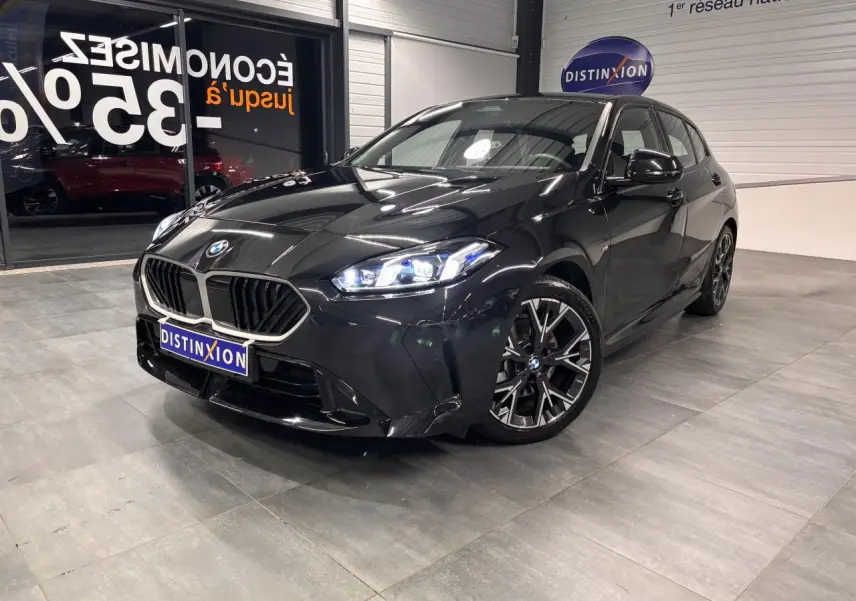 BMW Série 1 118d M Sport noir métal vue 3/4 avant droit avec calandre chromée et jantes 18 pouces bicolores.