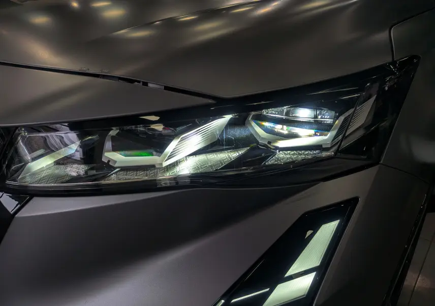 Gros plan sur le phare avant droit du Renault Rafale gris Schiste Satin, mettant en valeur son design LED moderne.