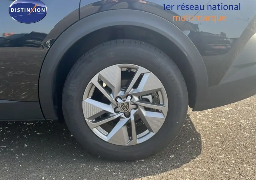Gros plan sur la roue avant gauche de la Peugeot 408 1.2 Hybrid 145ch Allure noire métal avec jante alliage distinctive.