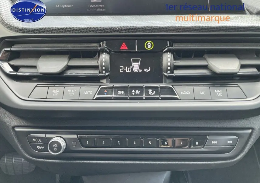 Vue rapprochée du tableau de bord de la BMW Série 1 gris minéral, montrant la console centrale et les commandes climatiques.