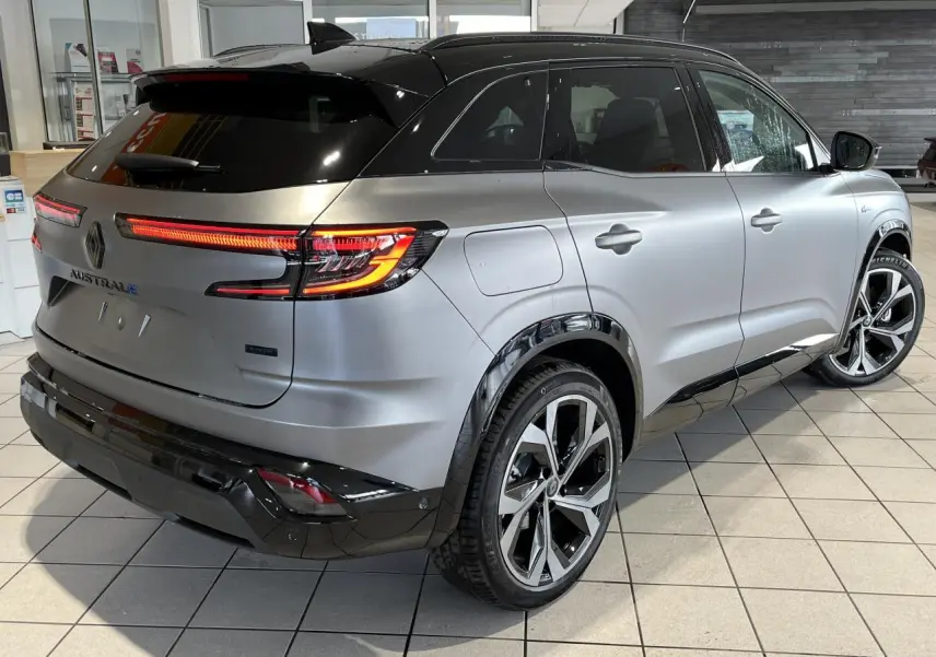 Vue 3/4 arrière droite du Renault Austral gris avec toit noir étoilé et jantes alliage 20 pouces diamantées.