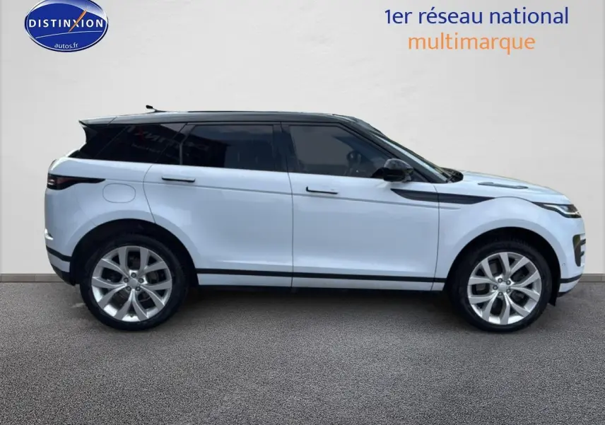 Profil droit d'un Range Rover Evoque blanc et noir de 2019 avec jantes alu et toit noir panoramique.