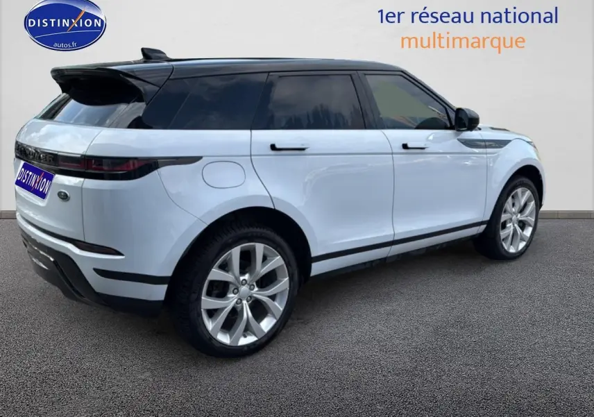 Range Rover Evoque blanc et noir vue 3/4 arrière côté gauche sur fond neutre.