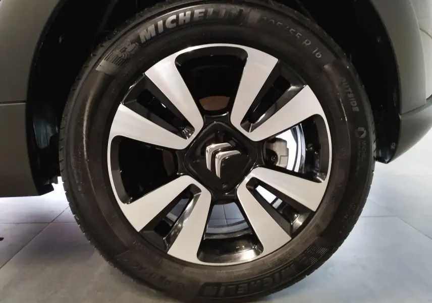 Gros plan sur la jante alliage 16 pouces diamantée noire et argentée de la Citroën C3 gris foncé, roue avant droite.