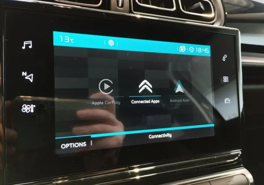 Écran tactile central de la Citroën C3 2024 affichant les options Apple CarPlay et Android Auto, avec tableau de bord noir.