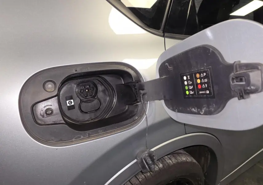 Vue rapprochée de la trappe de recharge côté gauche du Mazda CX-60 gris Sonic Silver 2023 hybride rechargeable.