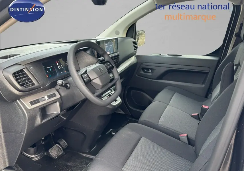 Intérieur avant droit du Citroën Jumpy Fourgon XL gris titane, montrant tableau de bord et sièges tissu gris noir.