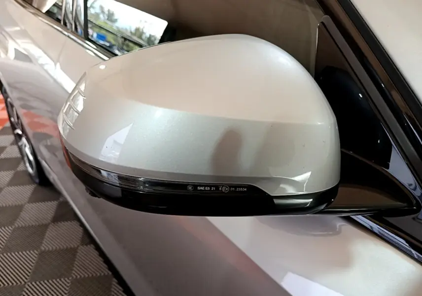 Rétroviseur droit gris clair de BMW X1 xDrive23i M Sport 2023 avec clignotant intégré, vue rapprochée en extérieur.