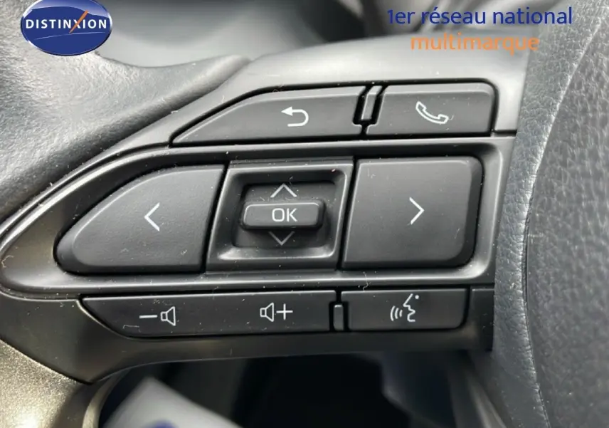 Gros plan sur les commandes multifonctions noires au volant du Toyota Yaris Cross blanc pur 2024.