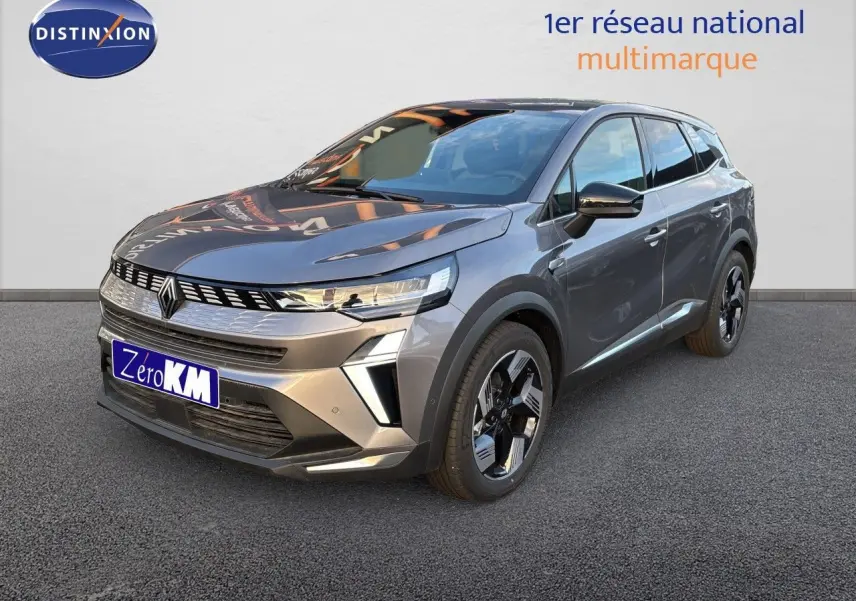 Renault Symbioz gris cassiopée métal en 3/4 avant droit, SUV hybride avec calandre moderne et jantes bicolores.
