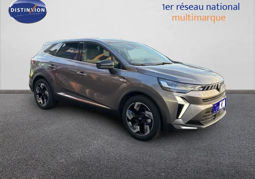 Renault Symbioz gris cassiopée métal vu en 3/4 avant droit, avec jantes bicolores et calandre moderne.