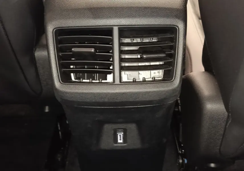 Vue rapprochée des aérateurs arrière noirs et prise USB du Citroën C5 Aircross 2024 côté arrière des sièges avant.