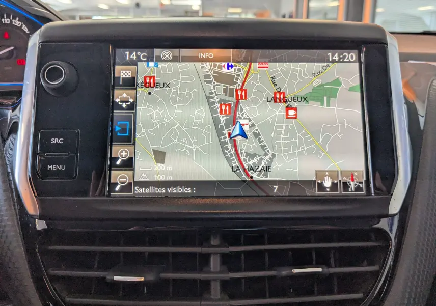 Écran tactile GPS en gros plan sur le tableau de bord d’une Peugeot 2008 gris Artense, affichant une carte détaillée.
