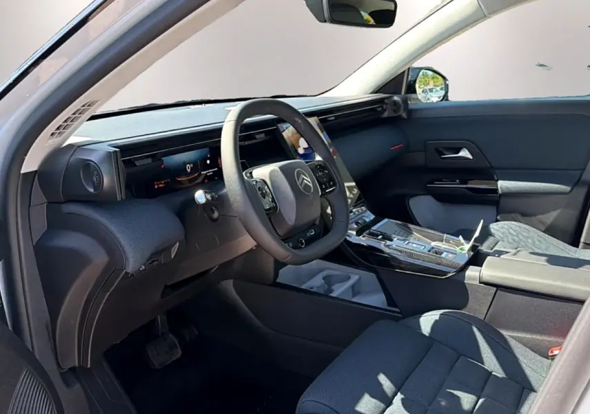 Intérieur du Citroën C5 Aircross 2026 vu côté conducteur, tableau de bord noir avec écran tactile et volant multifonction.
