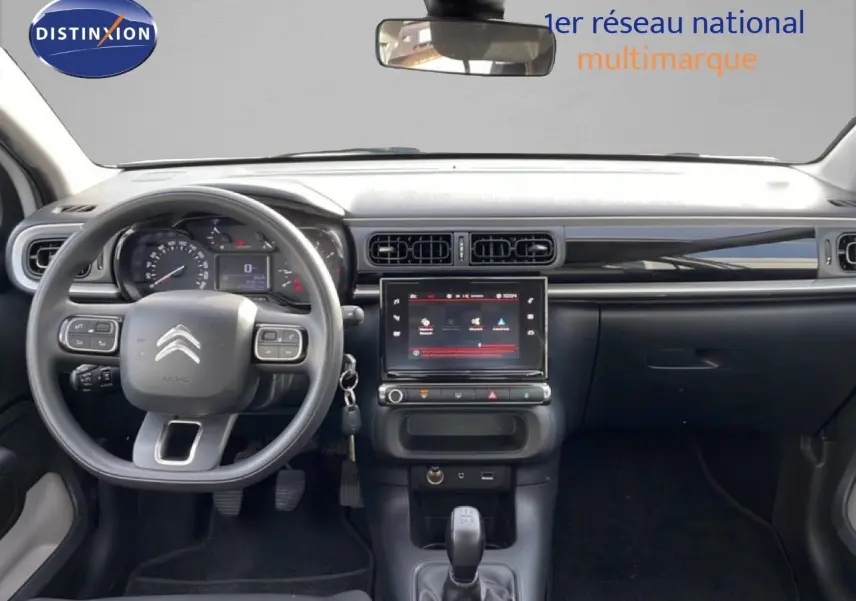 Vue intérieure frontale du tableau de bord noir de la Citroën C3 2018 avec volant multifonction et écran tactile central.