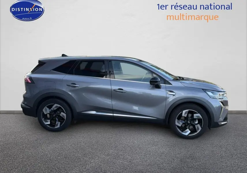 Profil droit d’un Renault Symbioz gris métallisé 2025 avec jantes noires et vitres arrière surteintées.