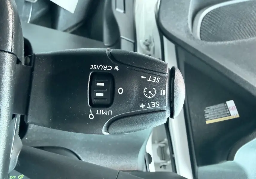 Gros plan sur la commande de régulateur de vitesse du Citroën Berlingo blanc 2019, côté gauche du volant.