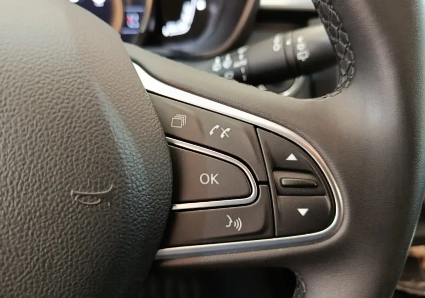 Gros plan sur les commandes multifonctions à droite du volant noir du Renault Kadjar Business Blue dCi 115 EDC 2022.