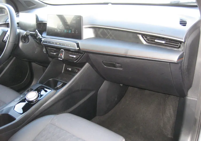 Vue intérieure côté passager du tableau de bord gris foncé du MG3 1.5 Hybrid Luxury avec écran tactile et console centrale moderne.