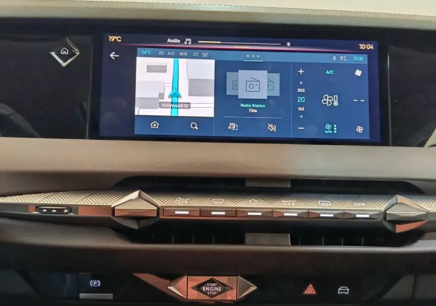 Vue rapprochée du tableau de bord tactile et des commandes de climatisation du DS4 E-TENSE gris clair de 2021.