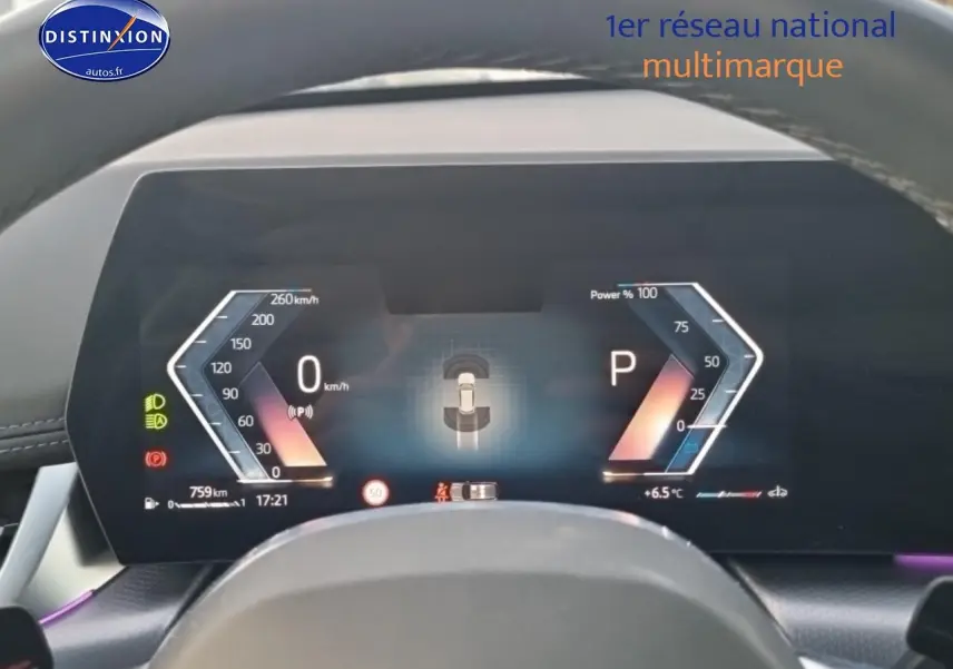 Vue rapprochée du tableau de bord numérique de la BMW X1 blanc minéral, affichant la vitesse et la position de la boîte auto.