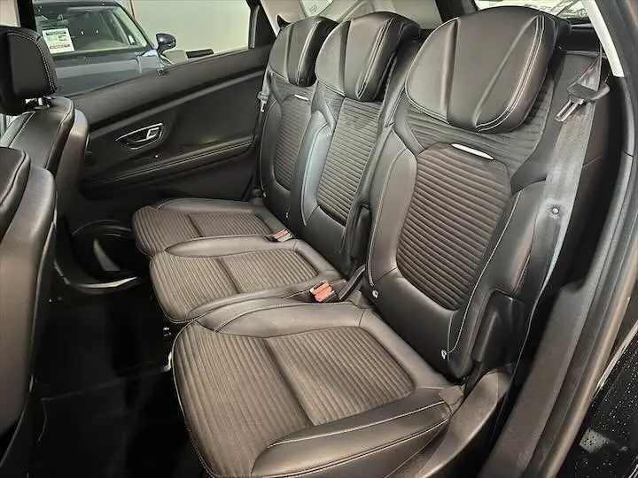 Vue intérieure côté droit des sièges arrière en cuir noir du Renault Scenic IV DCI 160 Energy Intens avec détails de couture apparents.