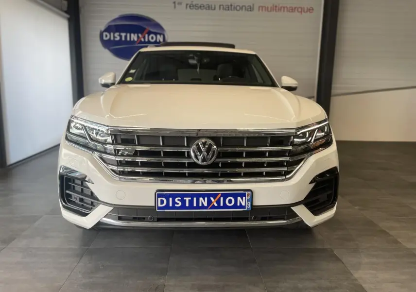 Vue frontale d’un Volkswagen Touareg blanc 2019 avec calandre chromée et logo VW bien visible.