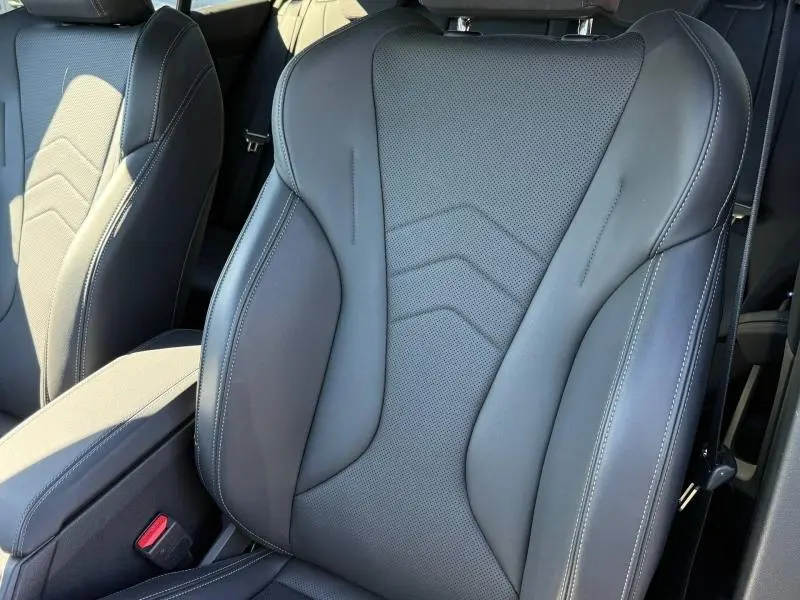 Gros plan sur le siège avant sport en cuir noir avec surpiqûres blanches de la BMW Série 1 120dA M Sport 2025.