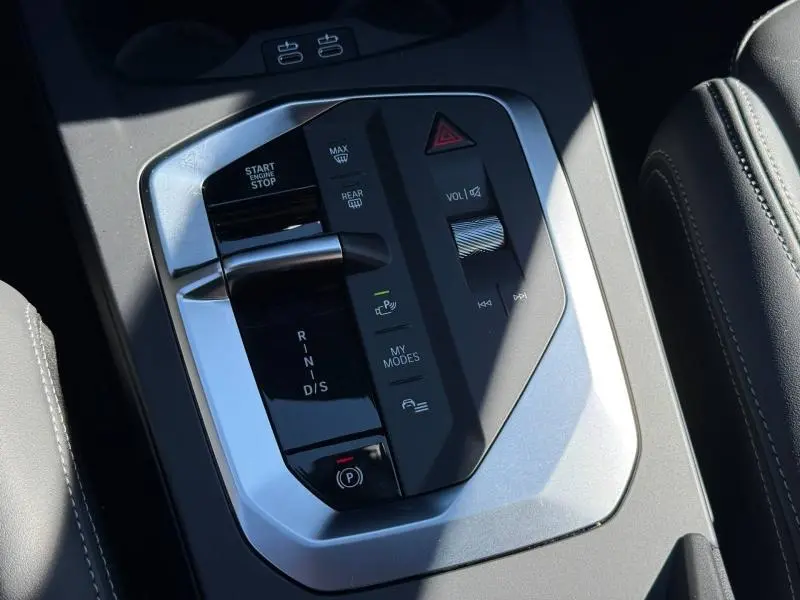 Gros plan sur la console centrale de la BMW Série 1 120dA M Sport, montrant le levier de vitesse et les commandes argentées.