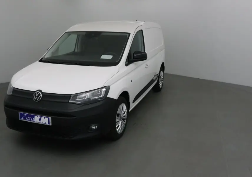 Vue 3/4 avant d'un utilitaire Volkswagen Caddy Maxi blanc avec bouclier noir et jantes argentées.