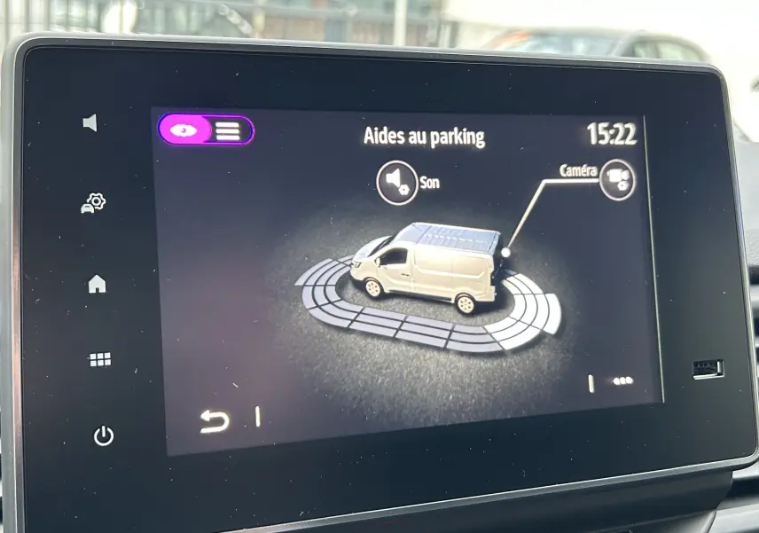 Écran tactile intérieur montrant l’aide au parking du Renault Trafic Fourgon gris Comète en vue latérale droite.