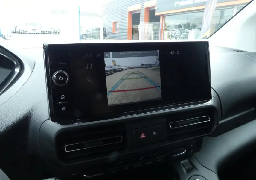 Écran tactile central affichant la caméra de recul dans l’habitacle du Peugeot Partner blanc, vue de face.